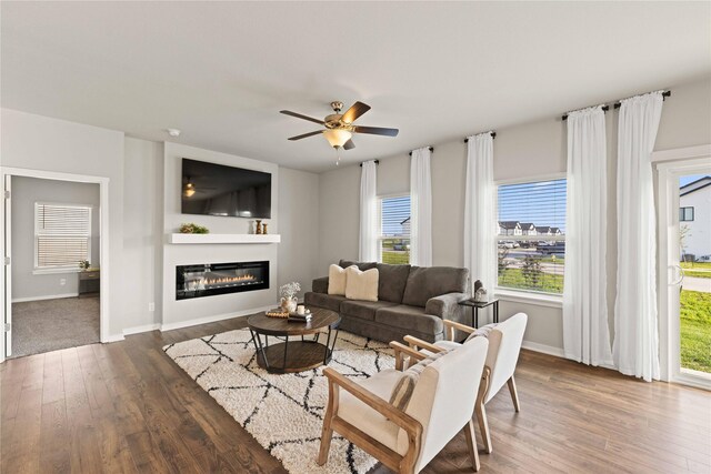10525 Powell Ave, Johnston, IA 50131 - living room with wood finished floors, a glass covered fireplace, and ceiling fan