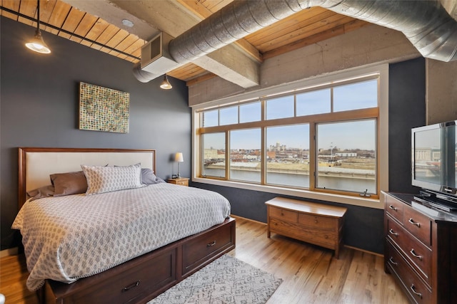 100 Market St Unit 409, Des Moines, IA 50309 - bedroom featuring light wood finished floors and a wooden ceiling with exposed beams