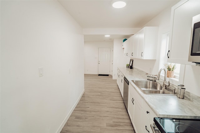3405 30th St, Des Moines, IA 50310 - kitchen with white cabinetry, light wood finished floors, light countertops, and appliances with stainless steel finishes