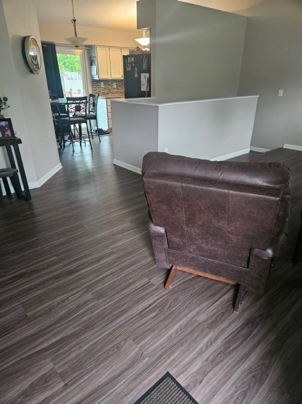 113 E 36th St, Des Moines, IA 50317 - living area featuring baseboards and dark wood-style floors