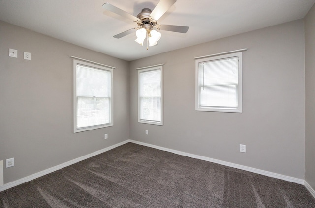 1012 28th St, Des Moines, IA 50311 - spare room featuring dark colored carpet and ceiling fan