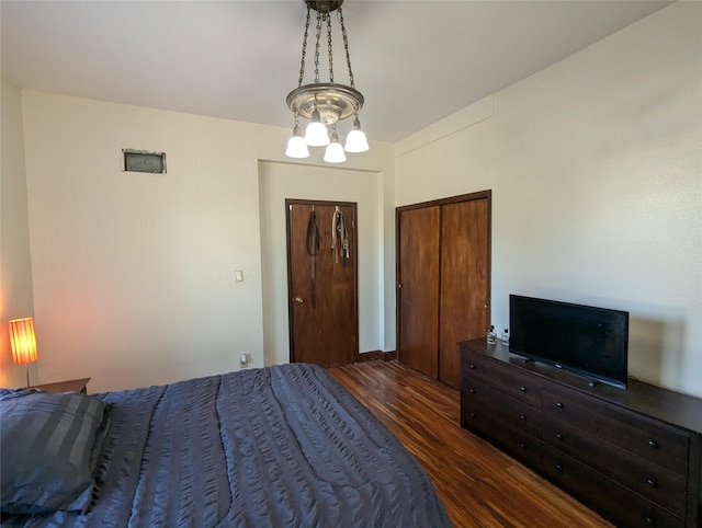 1418 E 9th St, Des Moines, IA 50316 - bedroom with wood finished floors and a chandelier