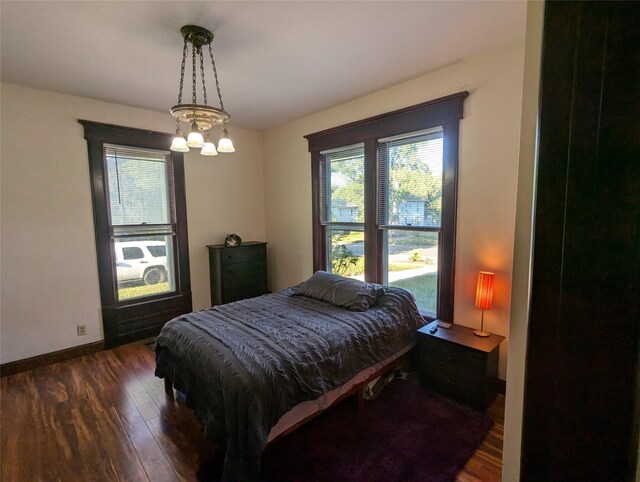 1418 E 9th St, Des Moines, IA 50316 - bedroom featuring wood-type flooring and a chandelier