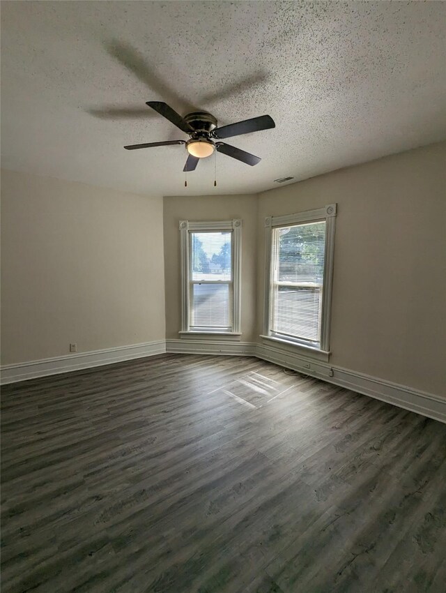 1418 E 9th St, Des Moines, IA 50316 - empty room featuring a textured ceiling, a ceiling fan, and dark wood-style floors