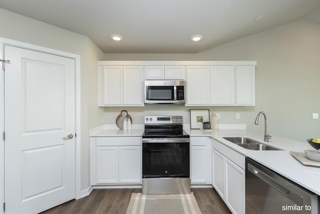 725 Linden St, Carlisle, IA 50047 - kitchen featuring stainless steel appliances, dark wood finished floors, white cabinetry, and recessed lighting