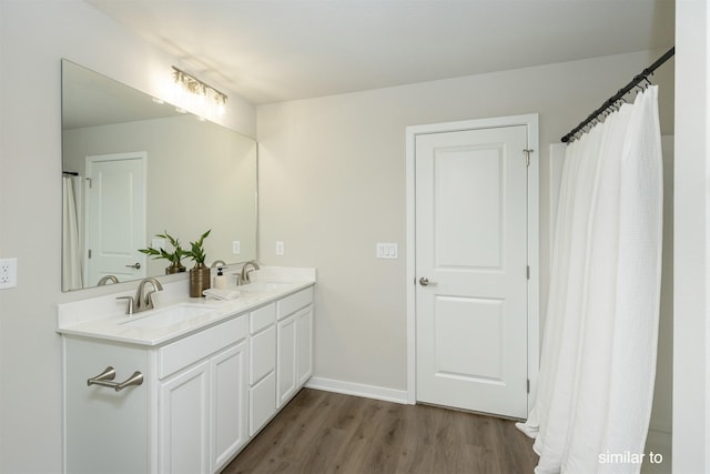 725 Linden St, Carlisle, IA 50047 - bathroom with wood finished floors and double vanity