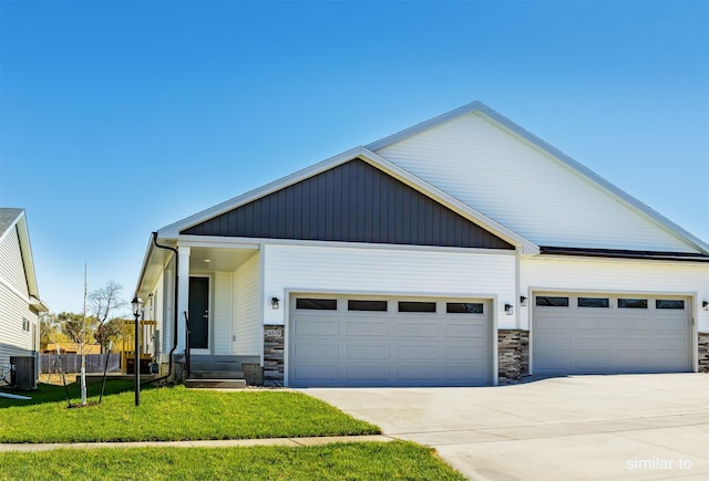 735 Linden St, Carlisle, IA 50047 - view of front facade with stone siding, an attached garage, and concrete driveway