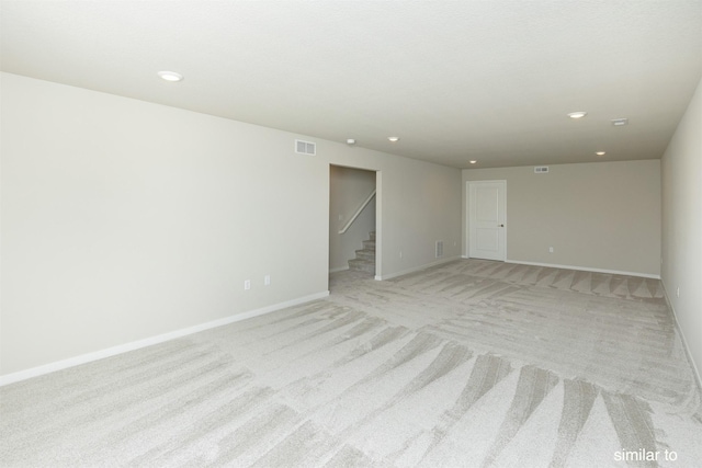 735 Linden St, Carlisle, IA 50047 - empty room featuring stairway, light colored carpet, and recessed lighting