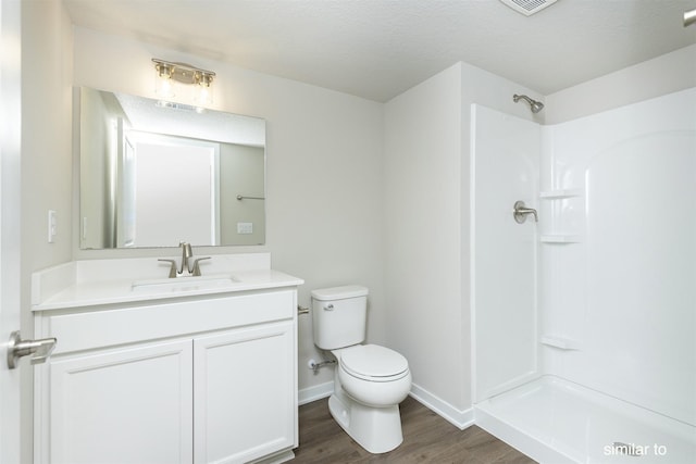 735 Linden St, Carlisle, IA 50047 - bathroom with wood finished floors, vanity, and a shower