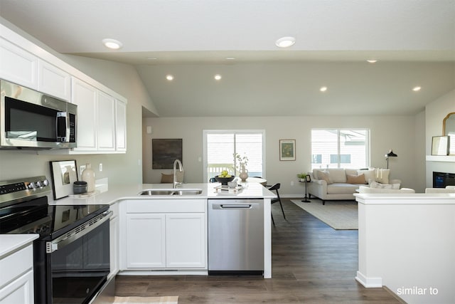 735 Linden St, Carlisle, IA 50047 - kitchen with appliances with stainless steel finishes, a peninsula, white cabinets, open floor plan, and recessed lighting