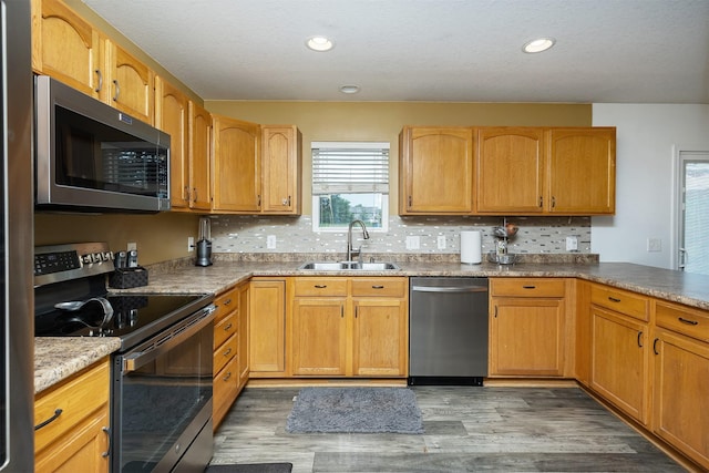 1205 Lancaster Way, Indianola, IA 50125 - kitchen with stainless steel appliances, wood finished floors, tasteful backsplash, and recessed lighting