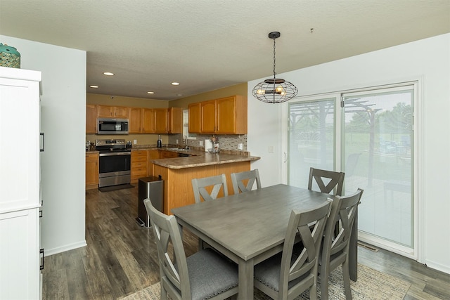 1205 Lancaster Way, Indianola, IA 50125 - dining room featuring plenty of natural light, dark wood-type flooring, recessed lighting, a chandelier, and a textured ceiling