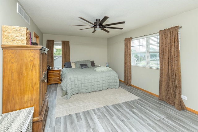 1205 Lancaster Way, Indianola, IA 50125 - bedroom with light wood-style flooring, multiple windows, and ceiling fan
