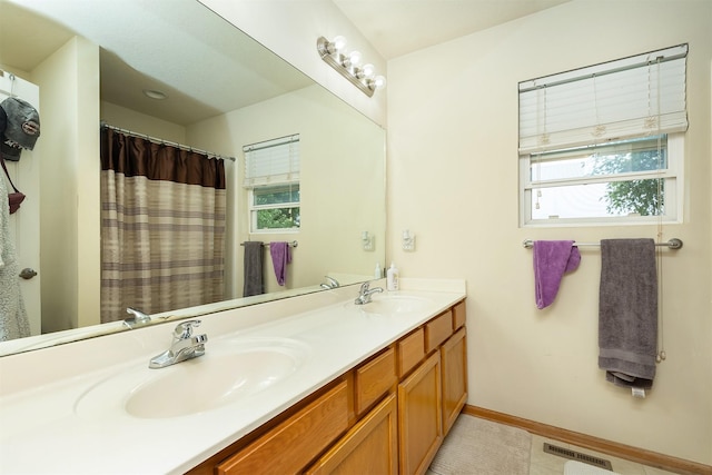 1205 Lancaster Way, Indianola, IA 50125 - bathroom featuring plenty of natural light and double vanity