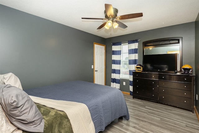 1205 Lancaster Way, Indianola, IA 50125 - bedroom featuring wood finished floors and a ceiling fan