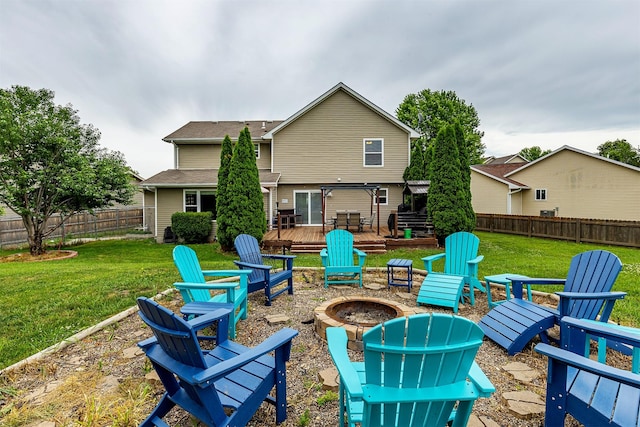 1205 Lancaster Way, Indianola, IA 50125 - rear view of house featuring a fire pit, a wooden deck, a fenced backyard, and roof with shingles