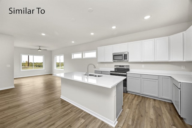 16732 Walnut Meadows Cir, Urbandale, IA 50323 - kitchen with appliances with stainless steel finishes, light wood-style flooring, plenty of natural light, light countertops, and recessed lighting