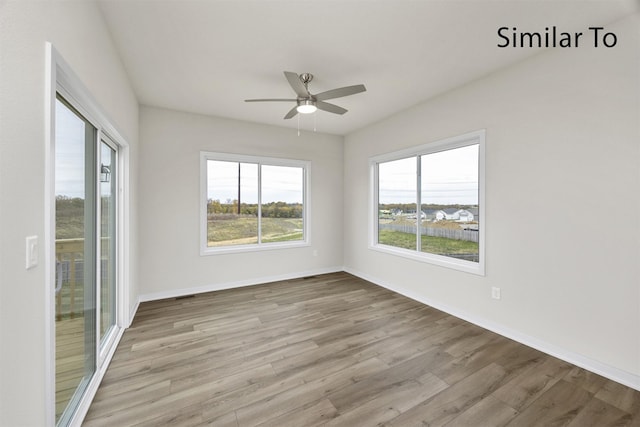16732 Walnut Meadows Cir, Urbandale, IA 50323 - spare room with wood finished floors and ceiling fan