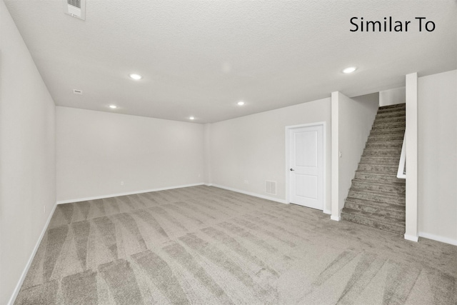 16732 Walnut Meadows Cir, Urbandale, IA 50323 - below grade area featuring carpet floors, stairs, recessed lighting, and a textured ceiling