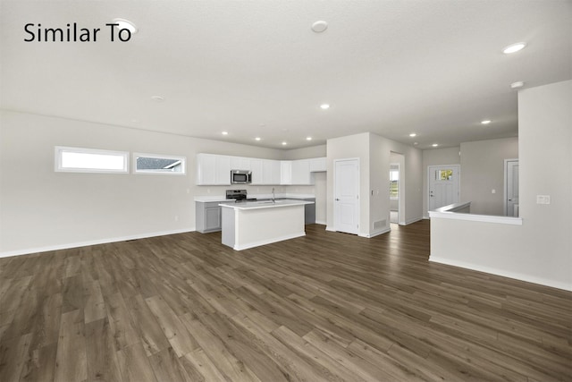 16738 Walnut Meadows Cir, Urbandale, IA 50323 - unfurnished living room with dark wood finished floors, plenty of natural light, and recessed lighting