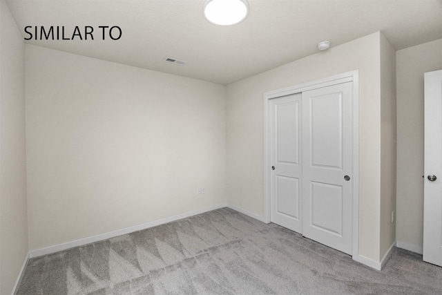 2212 Legacy Dr, Norwalk, IA 50211 - unfurnished bedroom with carpet floors and a closet