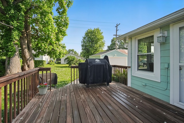604 W 2nd Ave, Indianola, IA 50125 - wooden deck with area for grilling and a yard