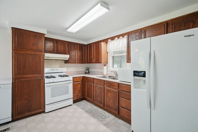 604 W 2nd Ave, Indianola, IA 50125 - kitchen with white appliances, under cabinet range hood, and light countertops