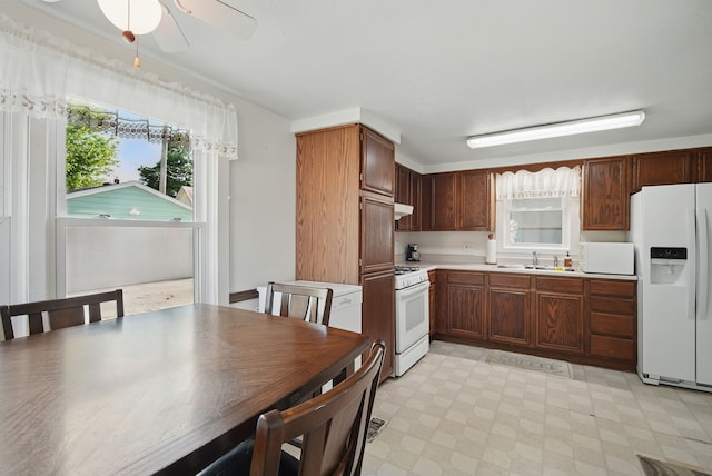 604 W 2nd Ave, Indianola, IA 50125 - kitchen with white appliances, light countertops, light flooring, and a ceiling fan