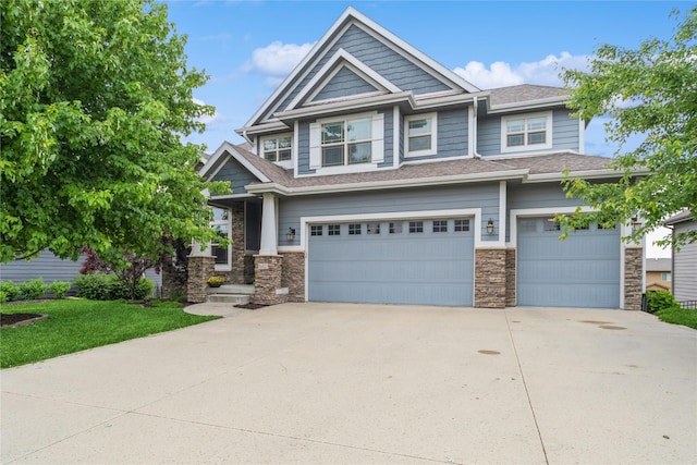 16823 Prairie Dr, Clive, IA 50325 - craftsman-style home with a garage, stone siding, driveway, and roof with shingles