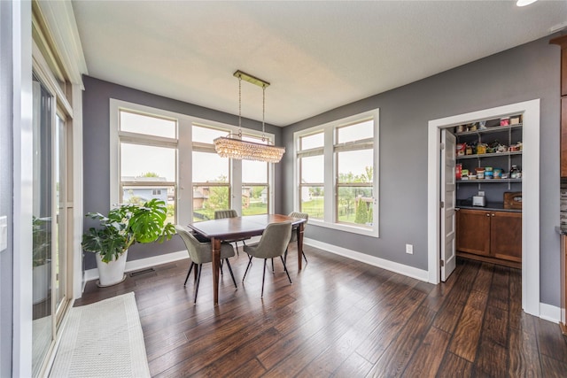 16823 Prairie Dr, Clive, IA 50325 - dining area with dark wood-type flooring and a chandelier