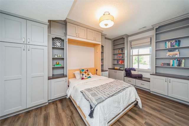 16823 Prairie Dr, Clive, IA 50325 - bedroom featuring dark wood-type flooring, a textured ceiling, and a closet