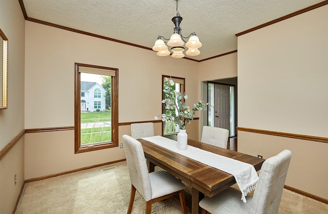 2216 NW 136th St, Clive, IA 50325 - dining area featuring a chandelier, light carpet, ornamental molding, and a textured ceiling