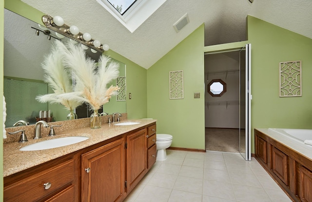 2216 NW 136th St, Clive, IA 50325 - full bathroom with vaulted ceiling, double vanity, a skylight, a textured ceiling, and tile patterned flooring