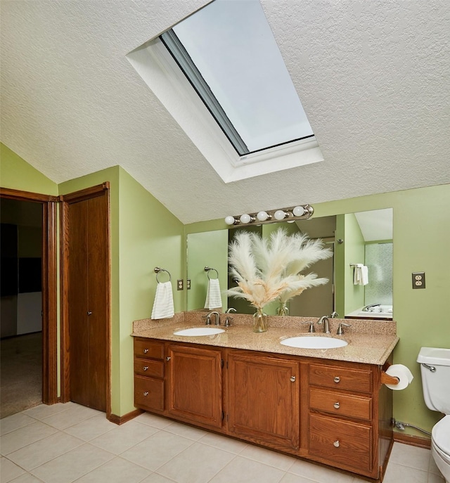 2216 NW 136th St, Clive, IA 50325 - full bath featuring a skylight, a textured ceiling, tile patterned flooring, lofted ceiling, and double vanity