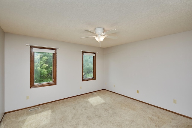 2216 NW 136th St, Clive, IA 50325 - empty room featuring carpet, a ceiling fan, and a textured ceiling