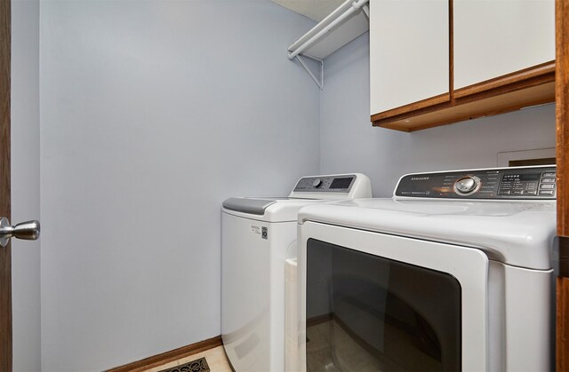 2216 NW 136th St, Clive, IA 50325 - washroom with separate washer and dryer, cabinet space, and light tile patterned floors