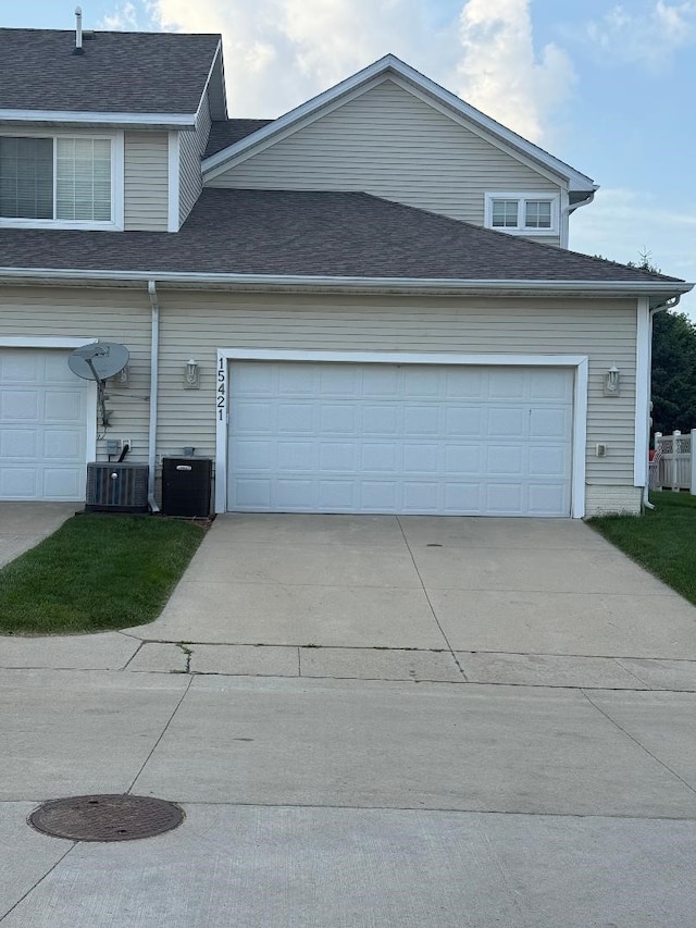 15421 Westbrook Dr, Urbandale, IA 50323 - view of home's exterior featuring concrete driveway, a shingled roof, and a garage
