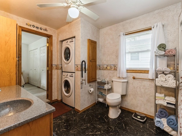 312 N J St, Indianola, IA 50125 - bathroom featuring stacked washer / drying machine, vanity, and ceiling fan