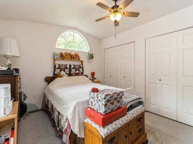 312 N J St, Indianola, IA 50125 - bedroom featuring light carpet, multiple closets, vaulted ceiling, and a ceiling fan