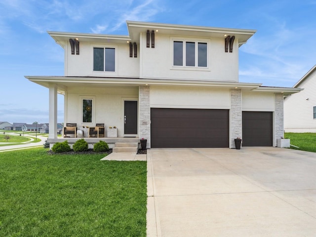 2502 Blooming Heights Dr, Norwalk, IA 50211 - view of front of home with stucco siding, a porch, a front yard, and concrete driveway