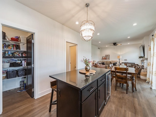 2502 Blooming Heights Dr, Norwalk, IA 50211 - kitchen featuring wine cooler, dark wood finished floors, a chandelier, recessed lighting, and open floor plan