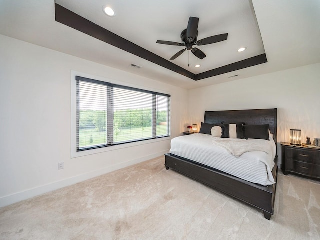 2502 Blooming Heights Dr, Norwalk, IA 50211 - bedroom featuring light colored carpet, a tray ceiling, recessed lighting, and a ceiling fan