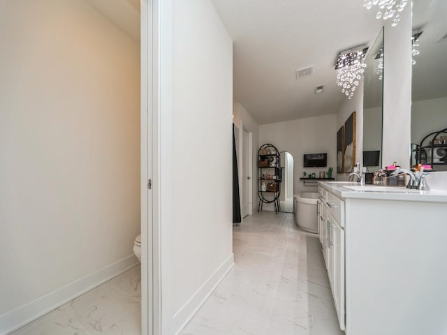 2502 Blooming Heights Dr, Norwalk, IA 50211 - bathroom with marble finish floors, double vanity, and a freestanding tub