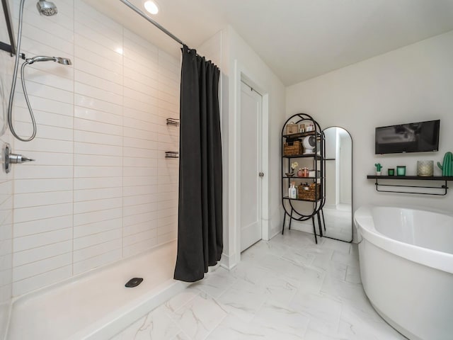 2502 Blooming Heights Dr, Norwalk, IA 50211 - bathroom featuring marble look tile flooring, a shower stall, and a freestanding bath