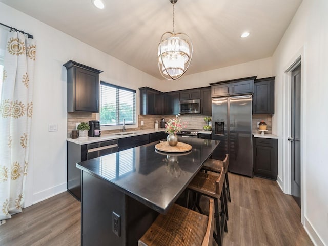 2502 Blooming Heights Dr, Norwalk, IA 50211 - kitchen with appliances with stainless steel finishes, a chandelier, dark wood-type flooring, tasteful backsplash, and recessed lighting