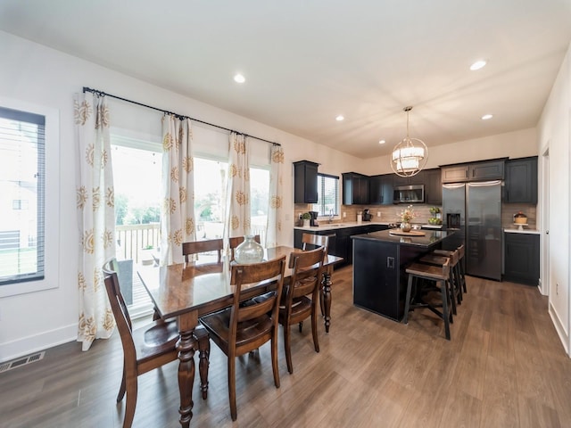2502 Blooming Heights Dr, Norwalk, IA 50211 - dining room with wood finished floors, recessed lighting, and a chandelier