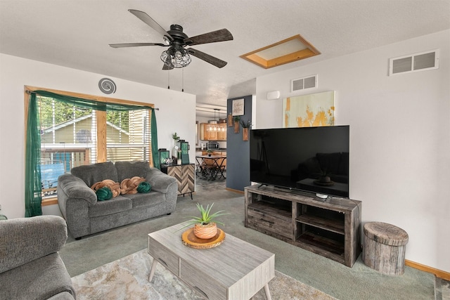 1334 E 13th St, Des Moines, IA 50316 - carpeted living room with ceiling fan and baseboards