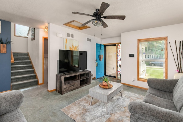 1334 E 13th St, Des Moines, IA 50316 - carpeted living room featuring ceiling fan and stairs