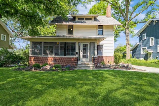 620 48th St, Des Moines, IA 50312 - american foursquare style home with brick siding, entry steps, a chimney, and a front lawn