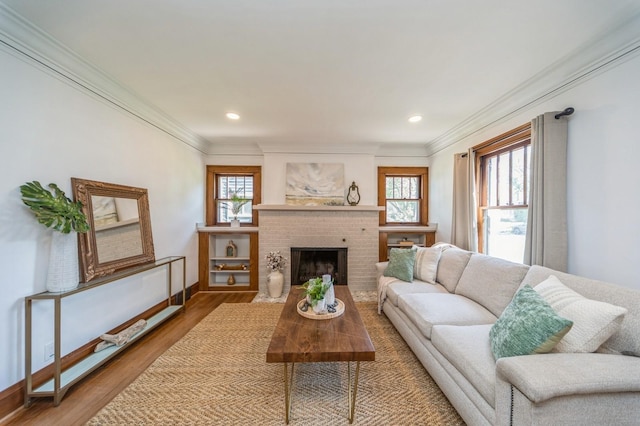 620 48th St, Des Moines, IA 50312 - living room with plenty of natural light, ornamental molding, wood finished floors, a fireplace, and recessed lighting